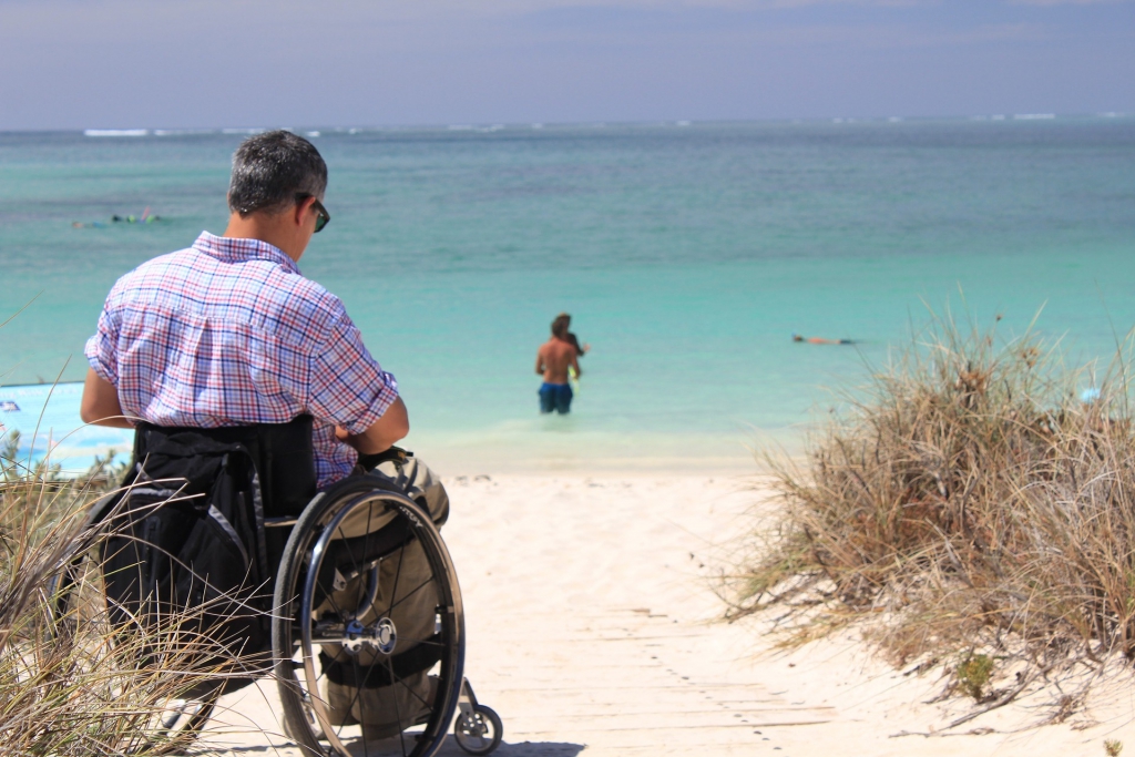 Man On Wheelchair At The Beach